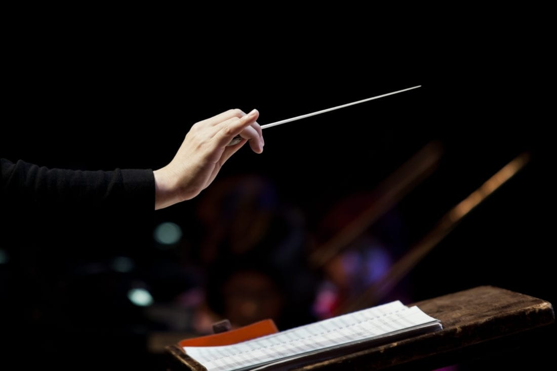 conductor's hand on a black background