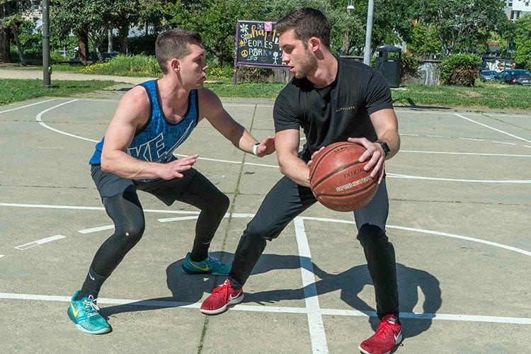 Cameron Haberman (left) and his identical twin brother Tyler play basketball in People’s Park. (Berkeley Haas photo by Jim Block)