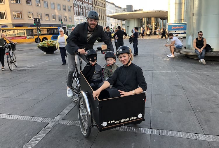 Robert Strand with sons, Mikkel (Batman), Jonas, and wife, Sarah, in Copenhagen on the iconic Christiana Bicycle made in Copenhagen, Denmark.