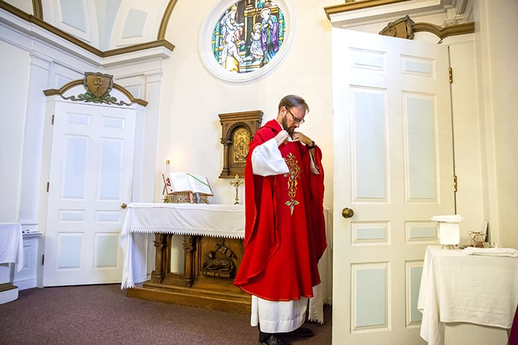 Father John Gribowich prepares to celebrate a weekday mass at the St. Joseph the Worker church in Berkeley. (UC Berkeley photo by Brittany Hosea-Small)</em>