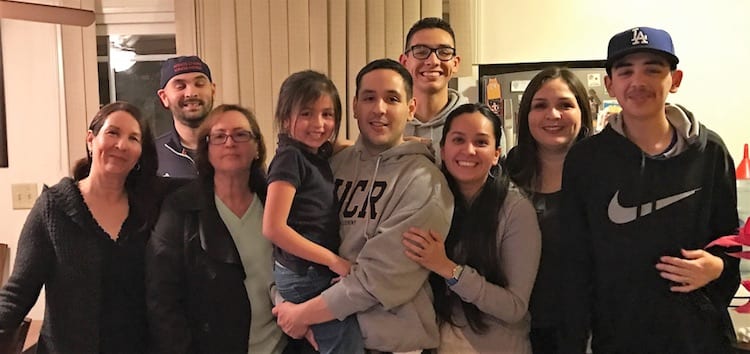 Rafael Sanchez, MBA 19, (front, center), surrounded by his family. L-R: Sanchez’s mother, Margarita; brother, Lino; aunt, Amanda; niece, Emily; nephew, Alex; sister, Kareen; sister, Vero; and nephew, Carlos.