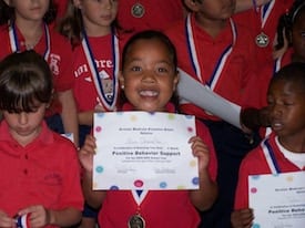 Mia Character accepting an award in elementary school.