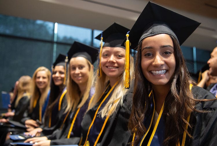 Photo of a group of women grads at undergrad commencement.