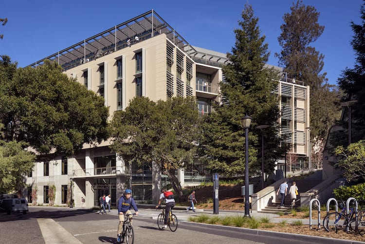 Photo of Chou Hall with cyclists passing