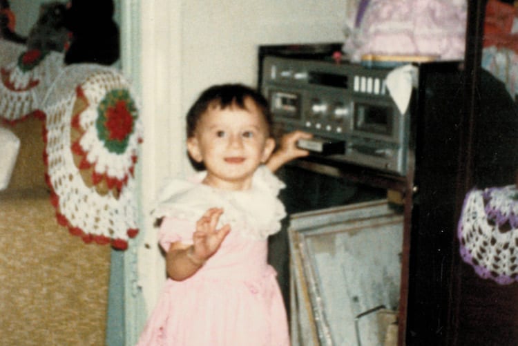 Brenda as a baby playing some tunes on her parents' stereo