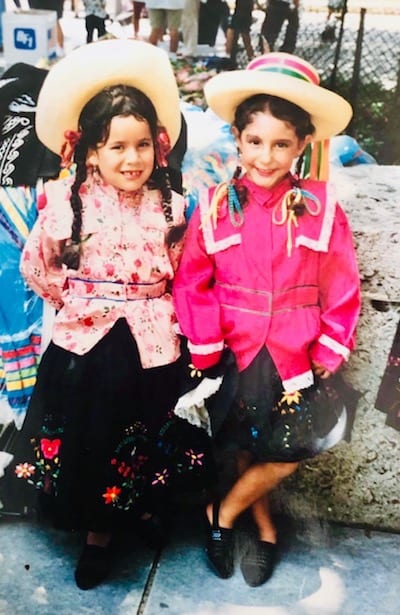 Five year old Paula (right) posing in costume with a fellow Mi Peru dancer before performing at a cultural festival in Texas.