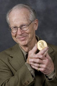 Prof. Oliver Williamson with his Nobel coin.
