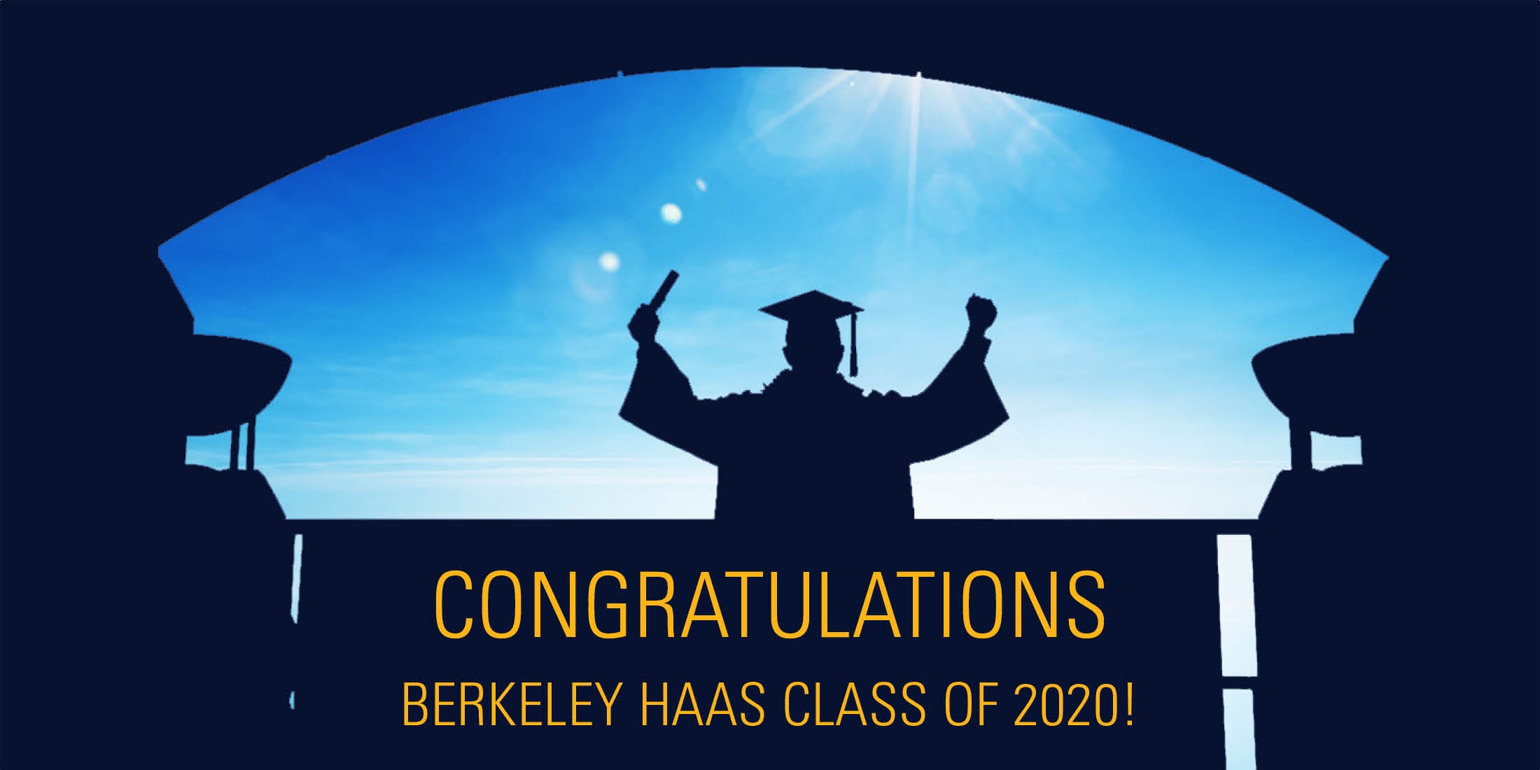 A Berkeley Haas graduate silhouetted under Cronk Arch at the entrance to the school