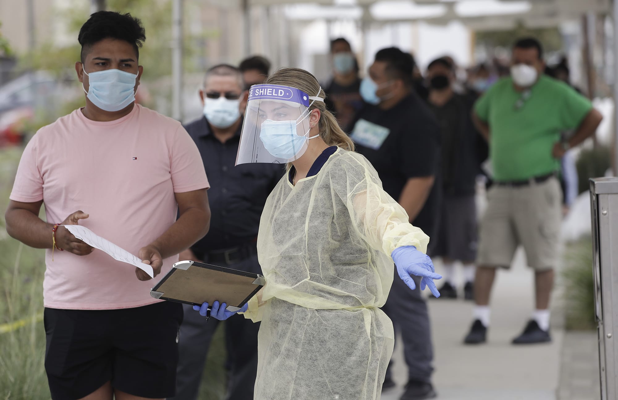 eople line up behind a health care worker at a mobile coronavirus testing site on July 22 at the Charles Drew University of Medicine and Science in Los Angeles.