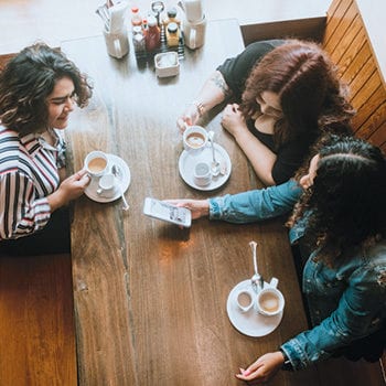 Three women at a cafe.