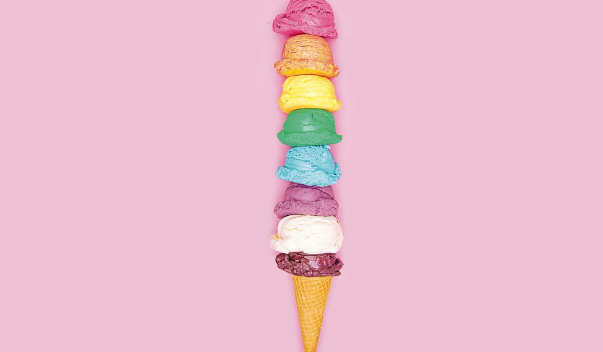 Ice cream cone with eight multi-colored scoops of ice cream.