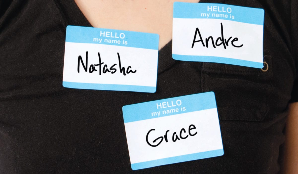 Person wearing three nametags: Natasha, Andre, and Grace.