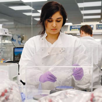 Scientist in a lab analyzing test kits.