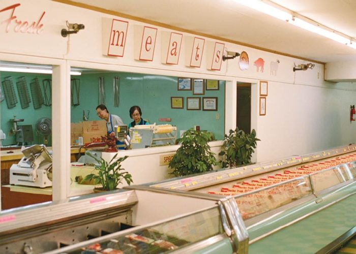 The interior and meat counter of Wong’s Foodland market