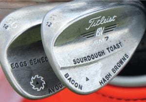 Collin Morikawa's golf clubs with breakfast foods stamped on them: eggs benedict, sourdough toast, bacon, and hash browns.