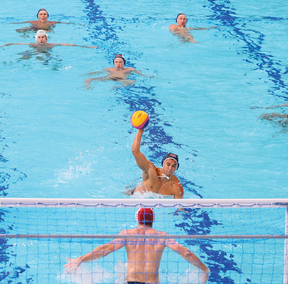 Johnny Hooper, BS 19, shooting a ball during a water polo match in the Olympics