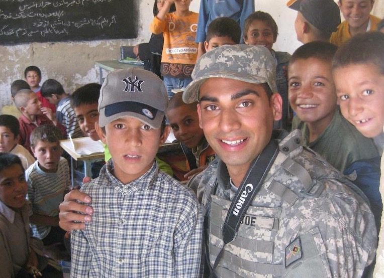 Junaid with boy wearing Yankees hat