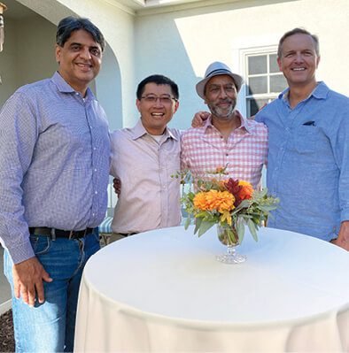 Arshad Carim, MBA 01, with classmates Raj Manghani, Dave Ko, and Todd Wehmann