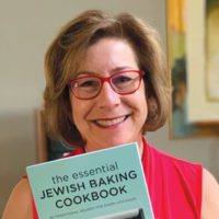 Beth Corman Lee, BS 85, holding her new book, The Essential Jewish Baking Cookbook.