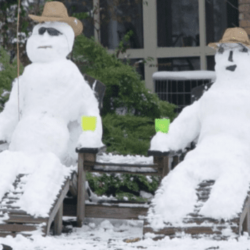 two snowmen sitting in lawn chairs