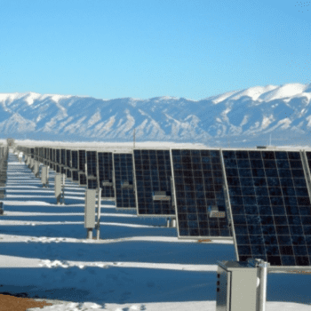 rows of solar panels. Snow-capped mountain range