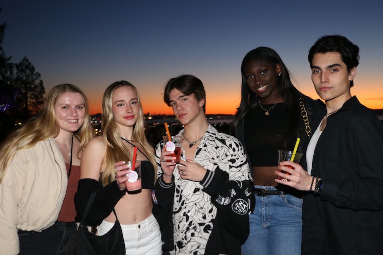 Students drinking boba at an Aura Tea rooftop party.