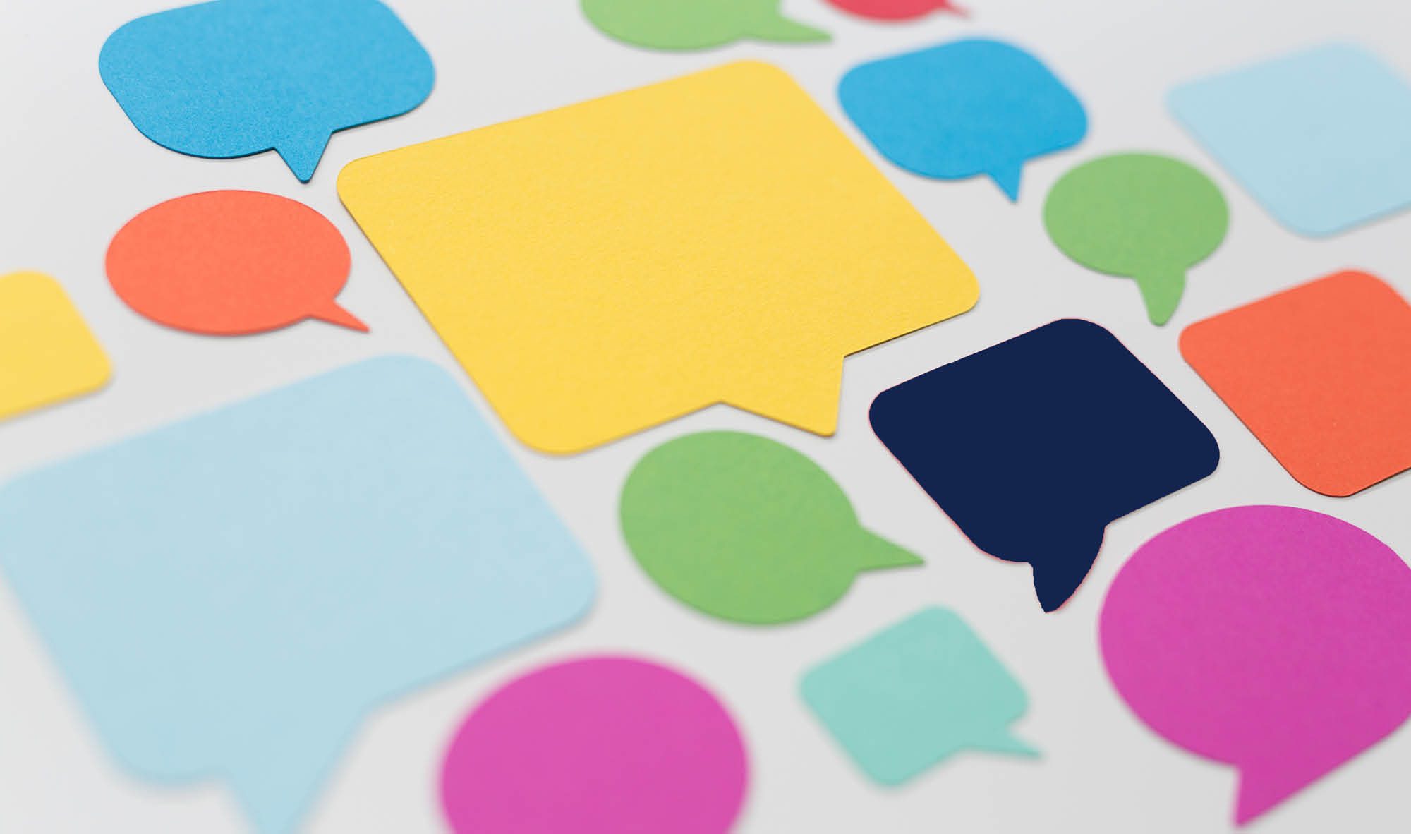 Multicolored post-it notes shaped like word clouds or thought bubbles.