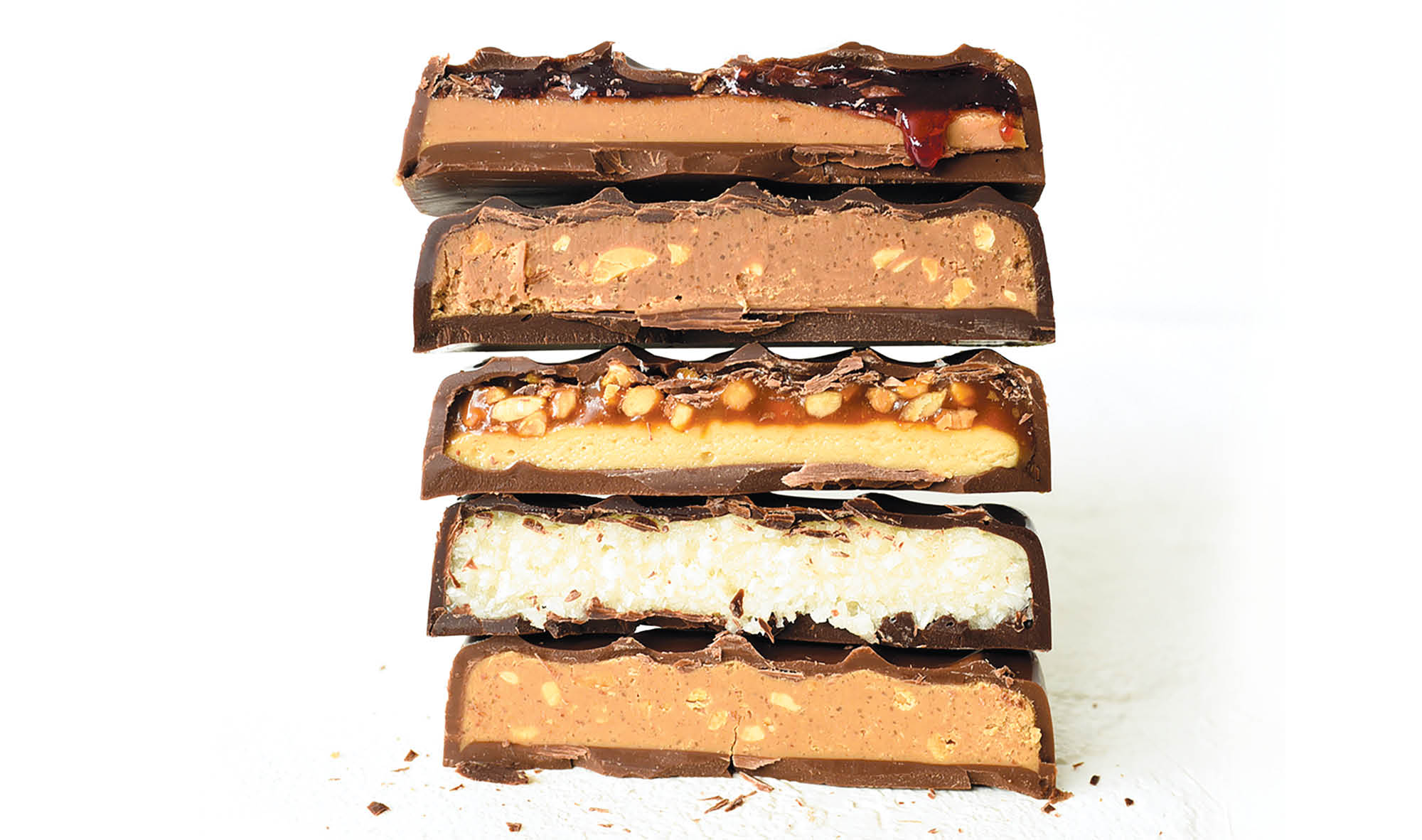 Cross-sections of five different Ocho candy bars stacked atop one another.