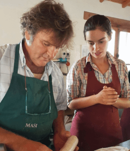Jude Watson learning to make sausage in a kitchen in Italy with a local butcher
