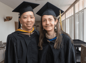 A woman and man dressed in academic regalia