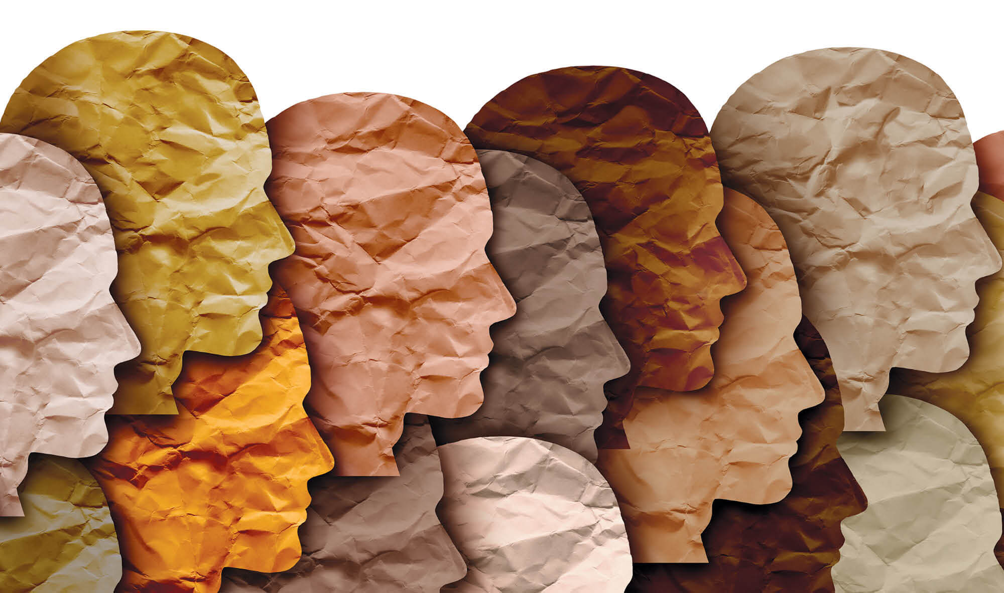 Crinkled-paper cut-outs of heads in various shades of skin tones.