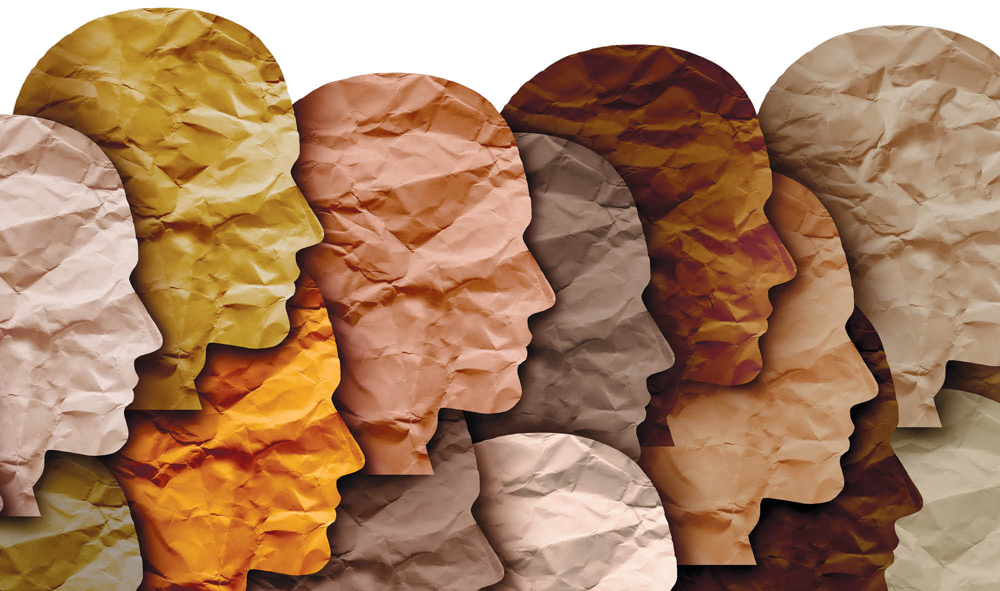 Crinkled-paper cut-outs of heads in various shades of skin tones.