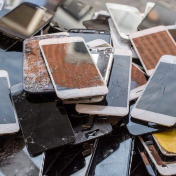 Stack of broken screens from smartphones