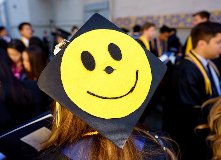 graduation cap with large smily face