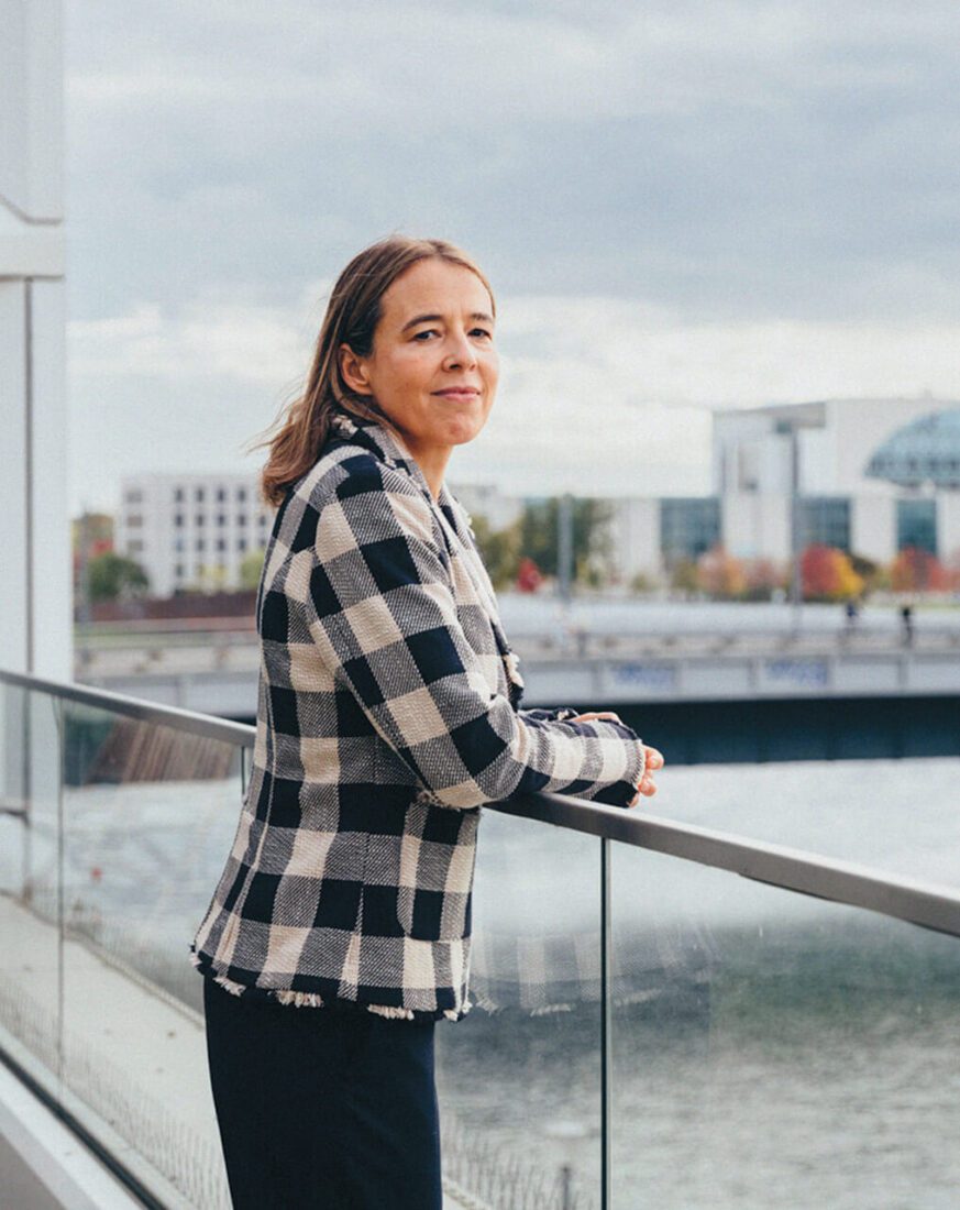 Woman standing at a railing looking out over the water in Berlin.