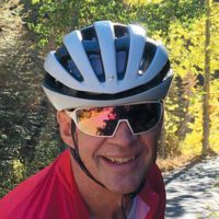 Brent Donaldson wearing a biking helmet and sunglasses.