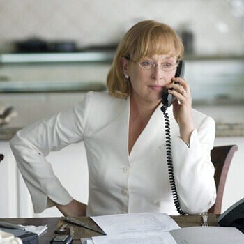 Actor Meryl Streep on the phone with a dour look on her face.