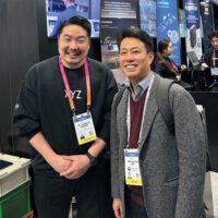 Jungwook Lim standing next to another man at a tech convention.