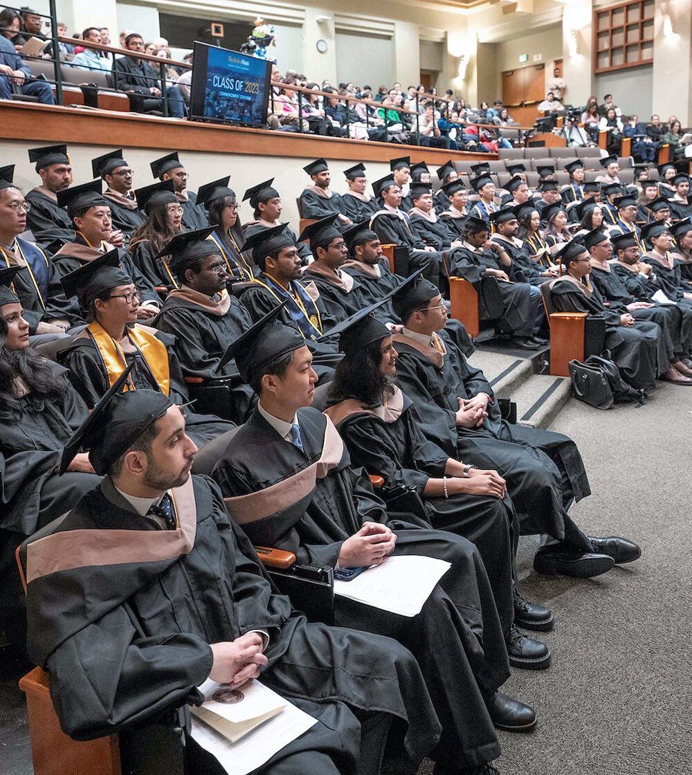 Graduating Class of 2023 seated in large auditorium.