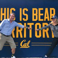 Ralph Garcia, Jr. and his wife in front of a sign reading This is Bear Territory.