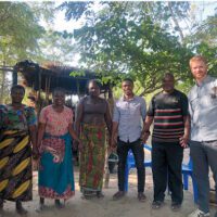 Sean Mandell standing with five other people in Malawi.