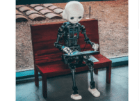 Picture of a robot sitting on a bench.