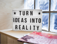 A picture of sign that reads "Turn ideas into reality".