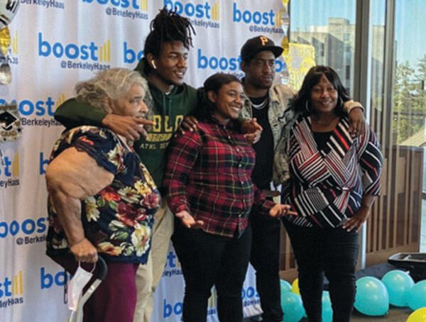 Five people standing in a line in a front of a backdrop that says Boost@BerkeleyHaas.