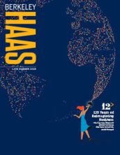 Cover of the summer 2023 issue of Berkeley Haas magazine showing a woman holding a graduation cap aloft. Brightly colored lights emanate from the cap, forming parts of the globe.