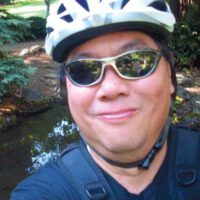 Edmund Fong in a bicycle helmet.