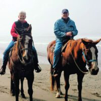 Flagg Taylor and Carole Taylor on horseback.