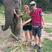 Steven Tannehill and wife, Marcia, standing next to an elephant.