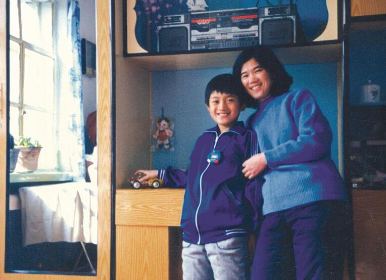 image of a polaroid photo of a mother and son inside a home.