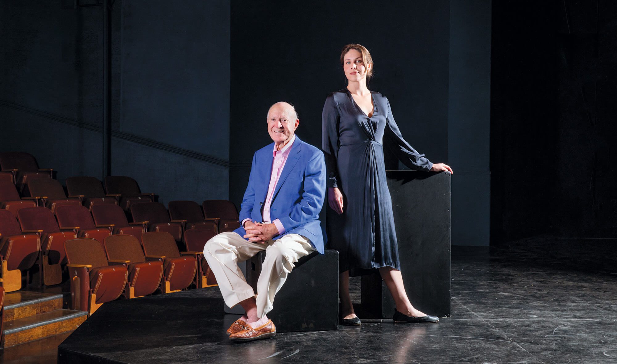 Tom Tusher, a former member of the Haas School Board, and Asha Culhane- Husain, BS 18 pictured together on the stage of a theater